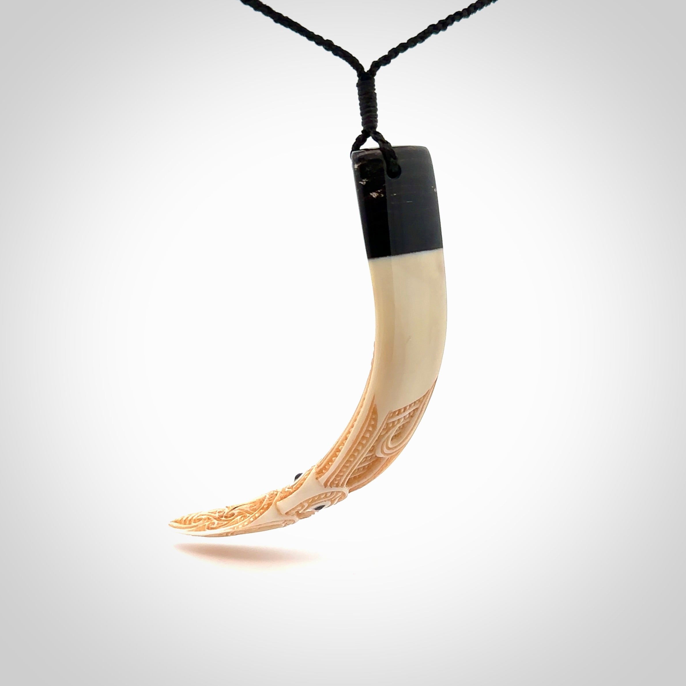 Hand carved Boars Tusk pendant with Buffalo horn and Paua Shell. Engraved large boars tusk pendant. Unisex necklace hand carved by Andrew Doughty here in New Zealand. Unique art to wear. Delivered with an adjustable black cord.