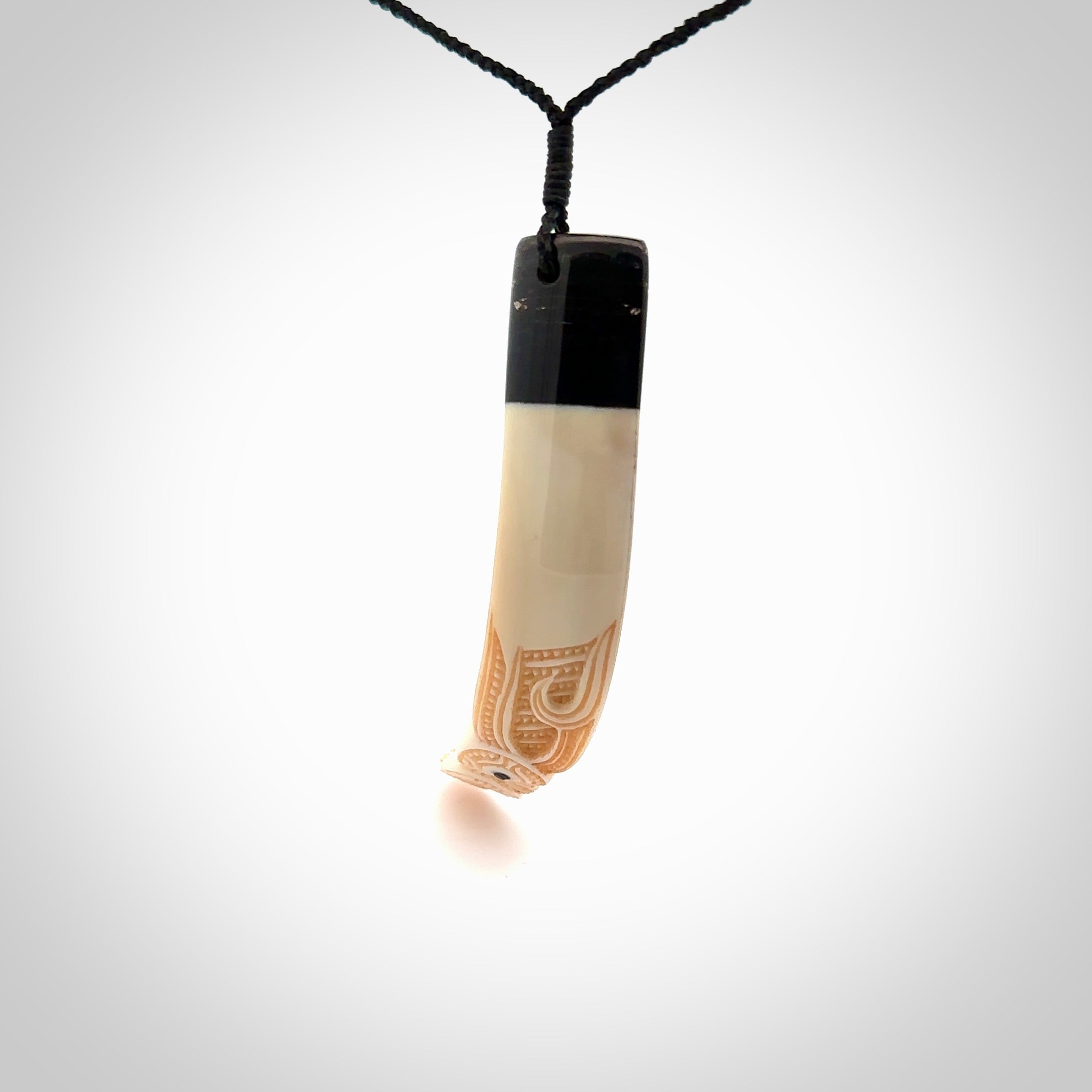 Hand carved Boars Tusk pendant with Buffalo horn and Paua Shell. Engraved large boars tusk pendant. Unisex necklace hand carved by Andrew Doughty here in New Zealand. Unique art to wear. Delivered with an adjustable black cord.