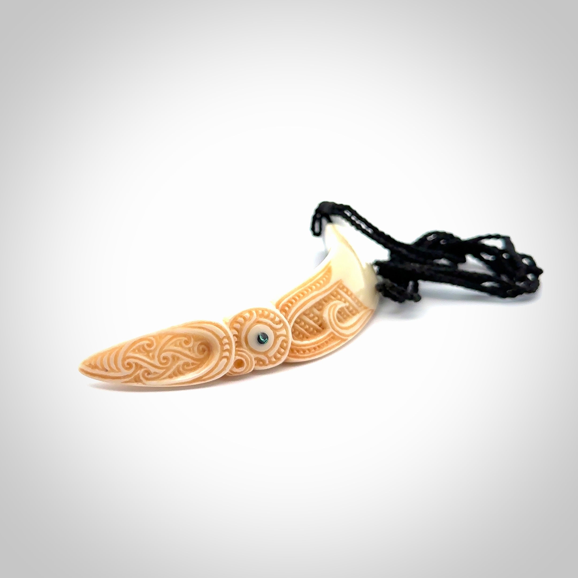 Hand carved Boars Tusk pendant with Buffalo horn and Paua Shell. Engraved large boars tusk pendant. Unisex necklace hand carved by Andrew Doughty here in New Zealand. Unique art to wear. Delivered with an adjustable black cord.