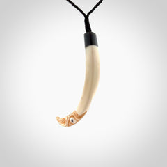 Hand carved Boars Tusk pendant with Buffalo horn, Paua Shell and Brass. Engraved large boars tusk pendant. Unisex necklace hand carved by Andrew Doughty here in New Zealand. Unique art to wear. Delivered with an adjustable black cord.