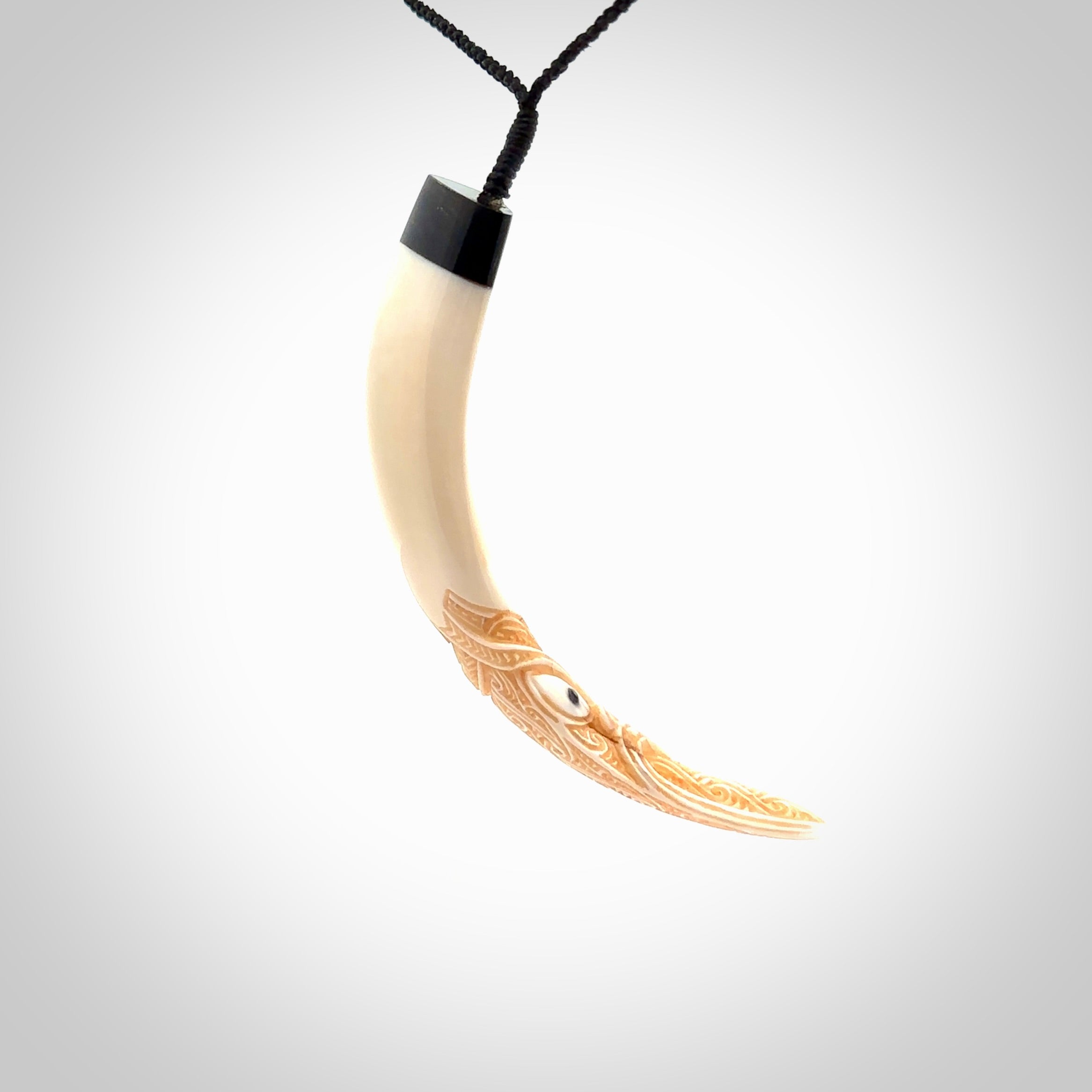 Hand carved Boars Tusk pendant with Buffalo horn, Paua Shell and Brass. Engraved large boars tusk pendant. Unisex necklace hand carved by Andrew Doughty here in New Zealand. Unique art to wear. Delivered with an adjustable black cord.