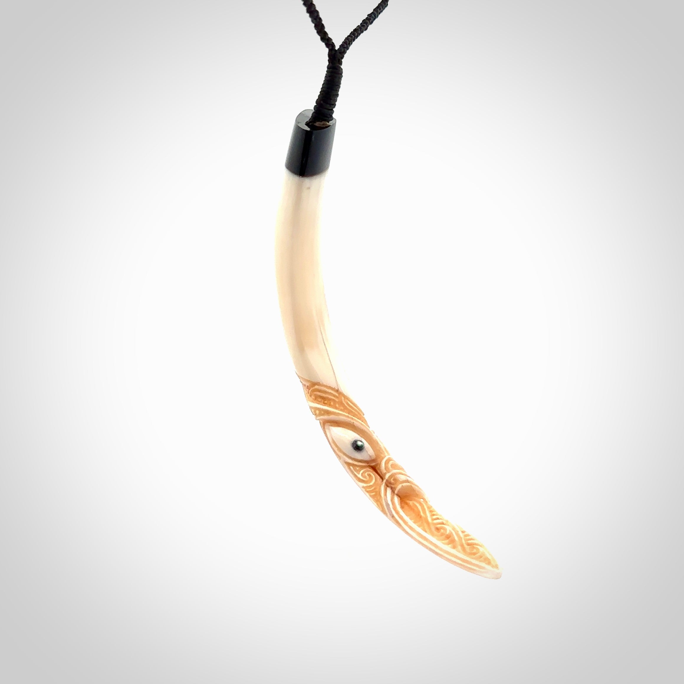 Hand carved Boars Tusk pendant with Buffalo horn, Paua Shell and Brass. Engraved large boars tusk pendant. Unisex necklace hand carved by Andrew Doughty here in New Zealand. Unique art to wear. Delivered with an adjustable black cord.