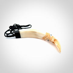 Hand carved Boars Tusk pendant with Buffalo horn, Paua Shell and Brass. Engraved large boars tusk pendant. Unisex necklace hand carved by Andrew Doughty here in New Zealand. Unique art to wear. Delivered with an adjustable black cord.