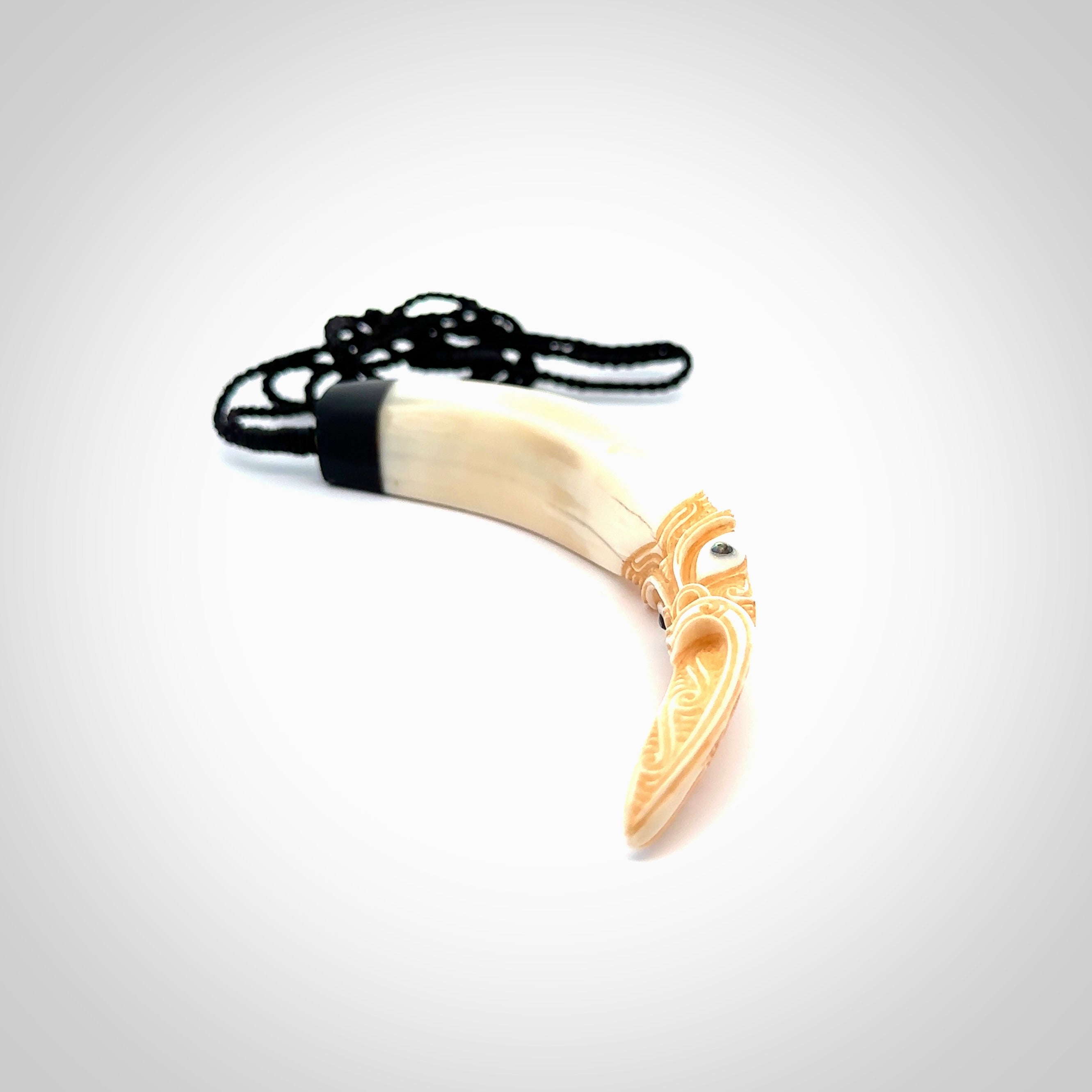 Hand carved Boars Tusk pendant with Buffalo horn, Paua Shell and Brass. Engraved large boars tusk pendant. Unisex necklace hand carved by Andrew Doughty here in New Zealand. Unique art to wear. Delivered with an adjustable black cord.