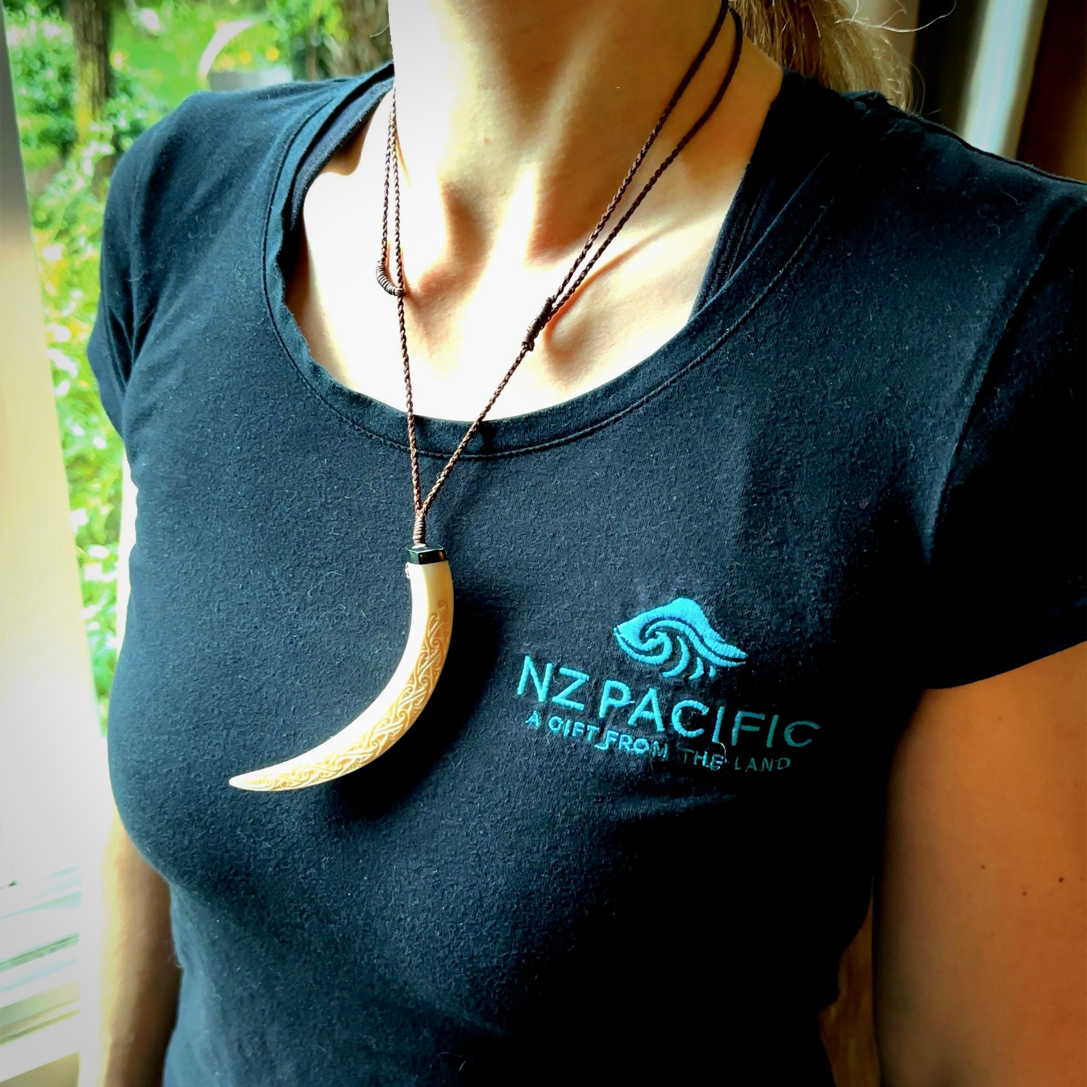 Hand carved Boars Tusk pendant with Buffalo horn, Mother of Pearl and Brass. Engraved large boars tusk pendant. Unisex necklace hand carved by Andrew Doughty here in New Zealand. Unique art to wear. Delivered with an adjustable brown cord.