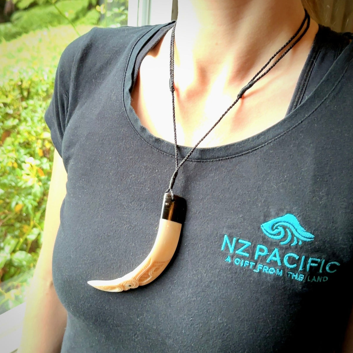 Hand carved Boars Tusk pendant with Buffalo horn and Paua Shell. Engraved large boars tusk pendant. Unisex necklace hand carved by Andrew Doughty here in New Zealand. Unique art to wear. Delivered with an adjustable black cord.