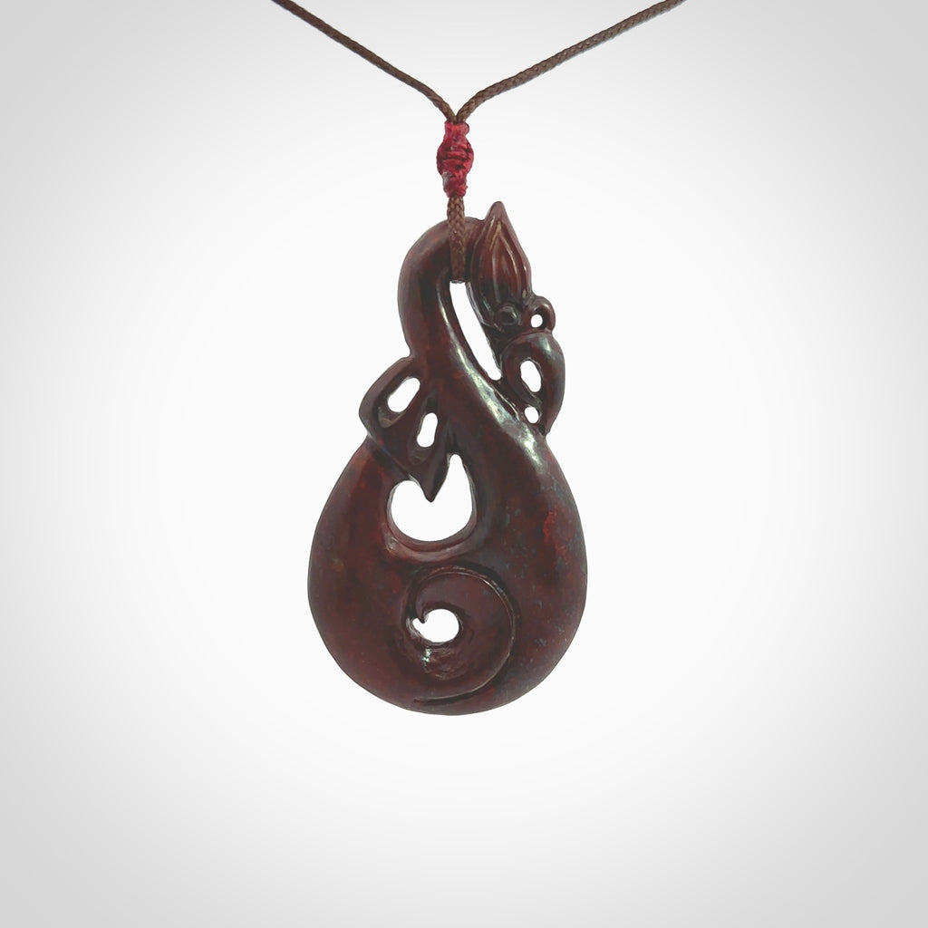 hand-carved-red-jasper-stone-manaia-with-koru-pendant-jasper-manaia