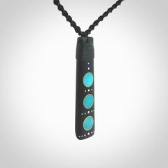 This photo shows a large sized Toki pendant hand carved from antique elephant statue with Sleeping Beauty Turquoise inlay alongside; brass and silver. This is a stand out one off necklace for those who appreciate art to wear. It is provided with a cord in black that is a fixed length with Paua Shell Toggle. We ship this piece worldwide and shipping is included in the price.