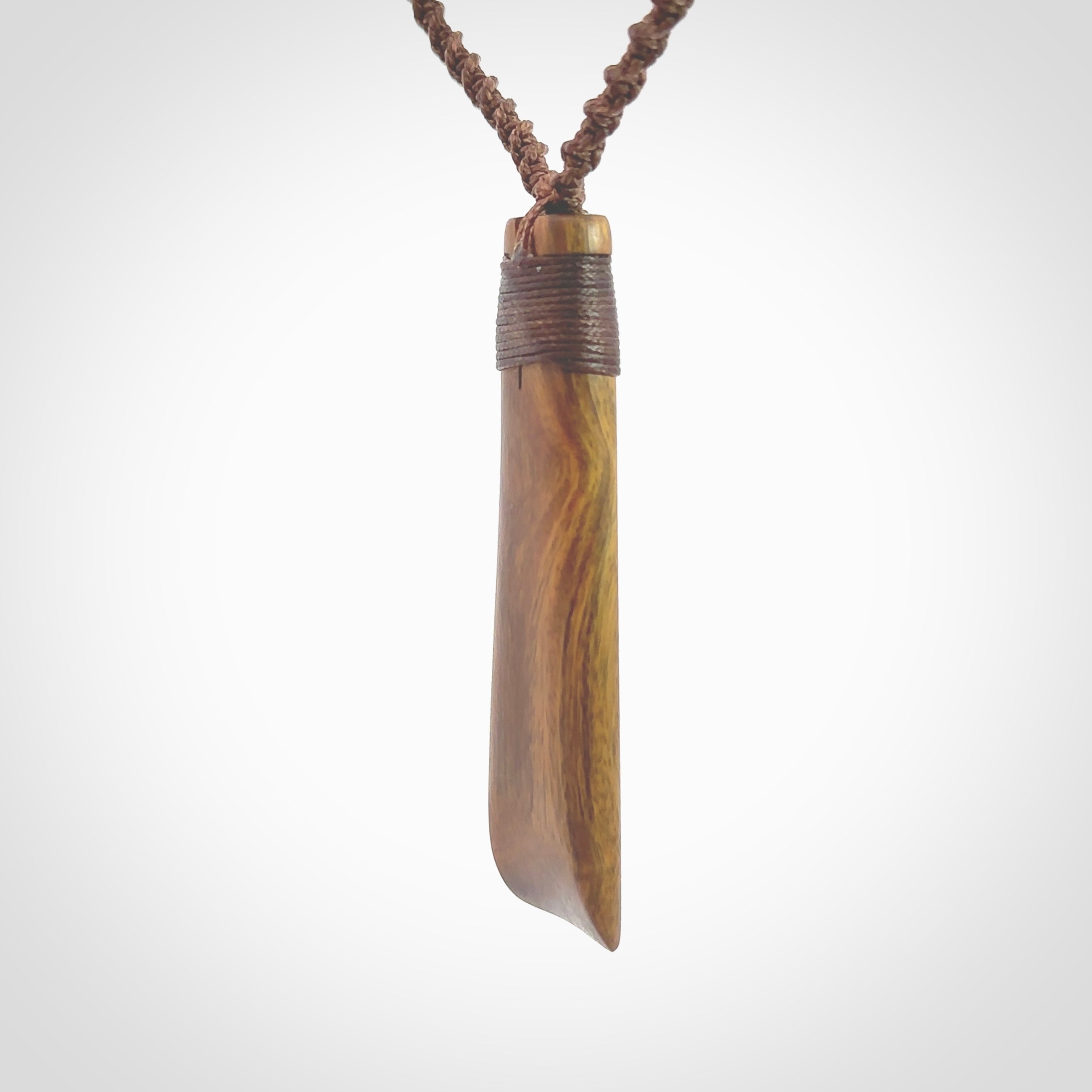 Hand carved wooden toki with triple Paua shell inlay, Silver and Brass. Stand out, one only, unique wooden Toki by Yannis Petzold. Delivered with a fixed length cord and Paua Shell Toggle. Delivered in a woven kete pouch.