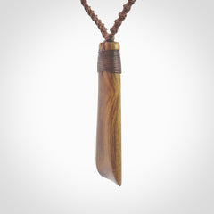 Hand carved wooden toki with triple Paua shell inlay, Silver and Brass. Stand out, one only, unique wooden Toki by Yannis Petzold. Delivered with a fixed length cord and Paua Shell Toggle. Delivered in a woven kete pouch.