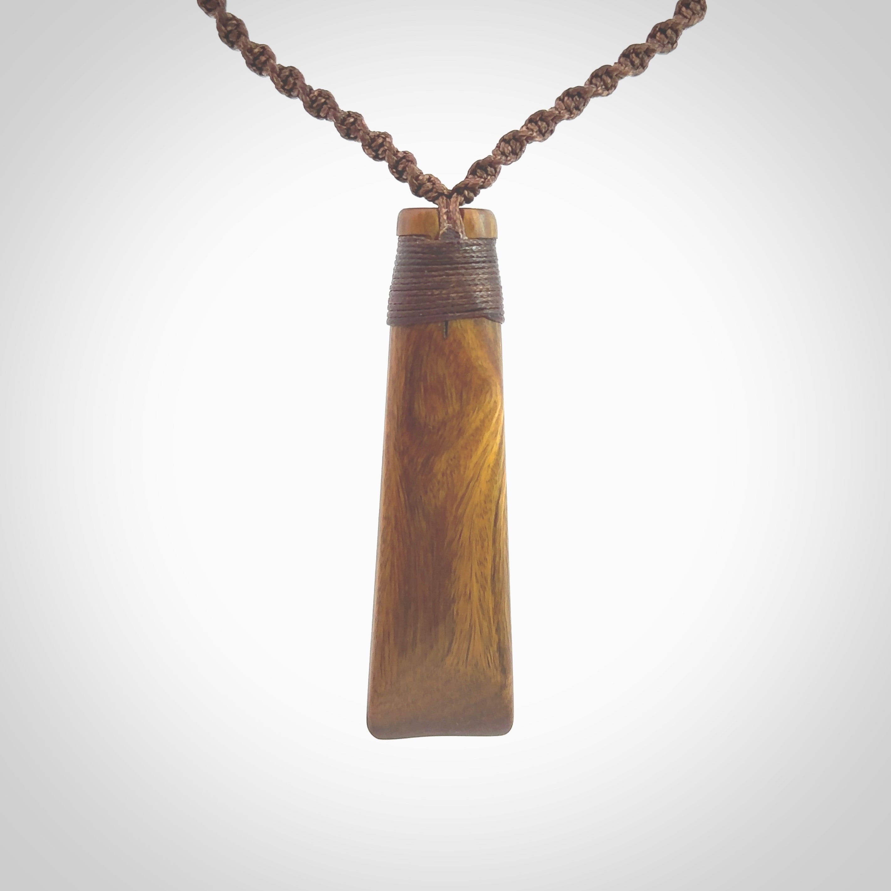 Hand carved wooden toki with triple Paua shell inlay, Silver and Brass. Stand out, one only, unique wooden Toki by Yannis Petzold. Delivered with a fixed length cord and Paua Shell Toggle. Delivered in a woven kete pouch.