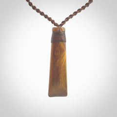 Hand carved wooden toki with triple Paua shell inlay, Silver and Brass. Stand out, one only, unique wooden Toki by Yannis Petzold. Delivered with a fixed length cord and Paua Shell Toggle. Delivered in a woven kete pouch.