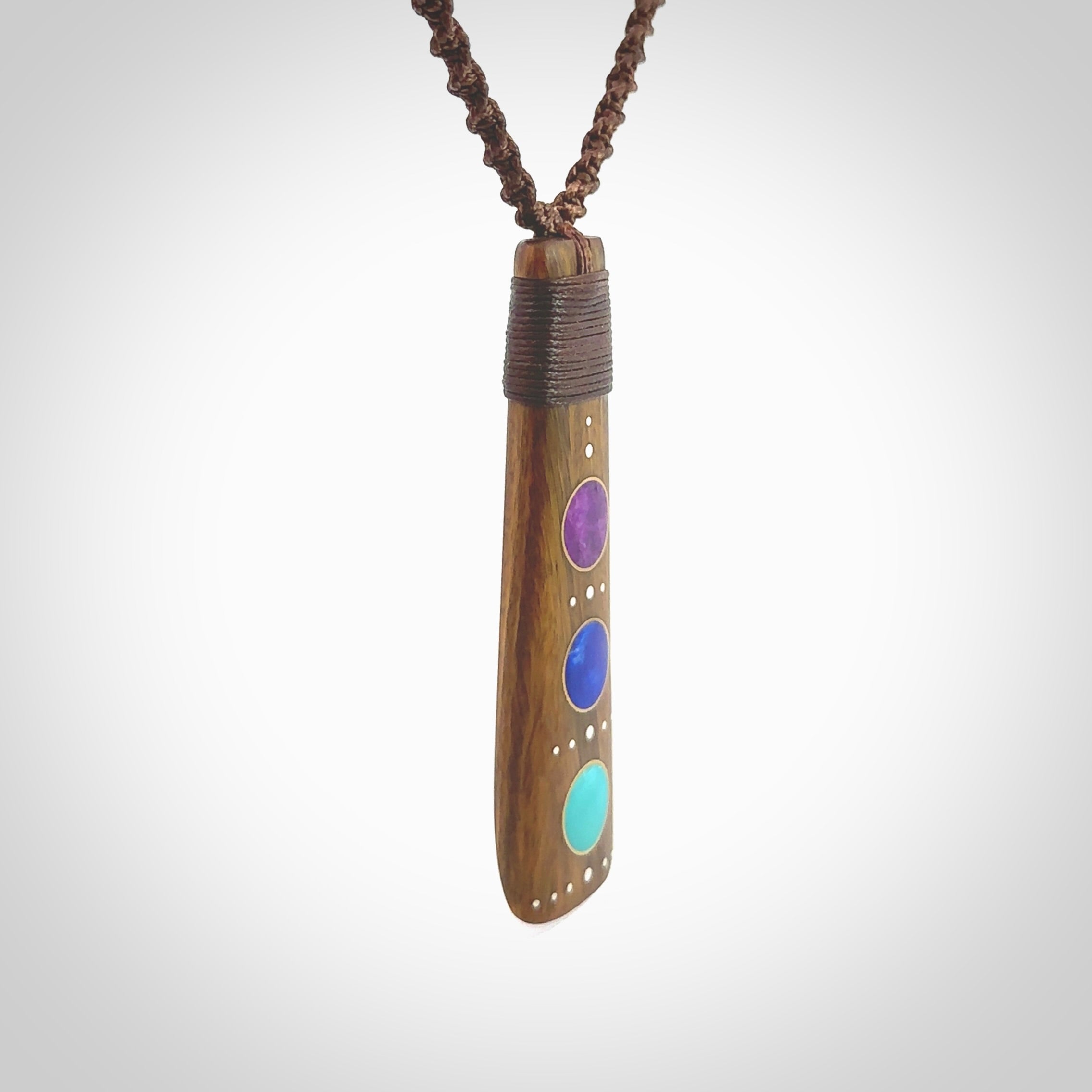 Hand carved wooden toki with Sleeping Beauty Turquoise, Lapis Lazuli and Amethyst inlay alongside Silver and Brass. Stand out, one only, unique wooden Toki by Yannis Petzold. Delivered with a fixed length cord and Paua Shell Toggle. Delivered in a woven kete pouch.