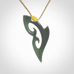 This photo shows a koru pendant carved from New Zealand Jade. The artist, Shaun Gardiner, has carved this beautifully. We provide this piece with an adjustable kalahari cord. This is a fantastic work of art, we have one only.