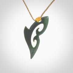 This photo shows a koru pendant carved from New Zealand Jade. The artist, Shaun Gardiner, has carved this beautifully. We provide this piece with an adjustable kalahari cord. This is a fantastic work of art, we have one only.