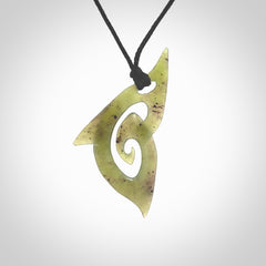 This photo shows a koru pendant carved from New Zealand Jade. The artist, Shaun Gardiner, has carved this beautifully. We provide this piece with an adjustable black cord. This is a fantastic work of art, we have one only.