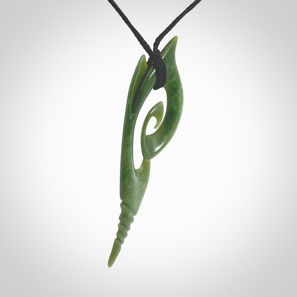 This photo shows a koru pendant carved from New Zealand Jade. The artist, Shaun Gardiner, has carved this beautifully. We provide this piece with an adjustable black cord. This is a fantastic work of art, we have one only.