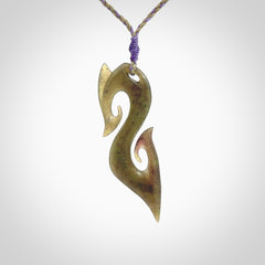 This photo shows a koru pendant carved from New Zealand Jade. The artist, Shaun Gardiner, has carved this beautifully. We provide this piece with an adjustable safari green/lilac cord. This is a fantastic work of art, we have one only.