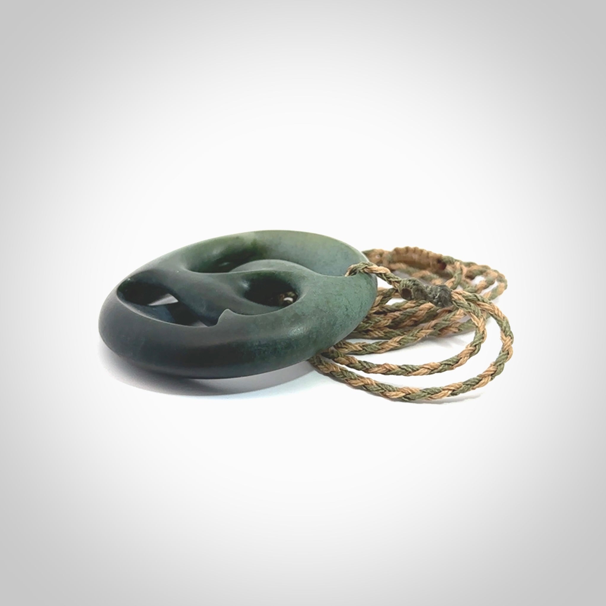 Hand carved New Zealand jade, complex twist drop pendant. Hand made complex twist pendant hand carved in New Zealand. Made by NZ Pacific, jade jewellery for sale online. One only hand made by Kerry Thompson.