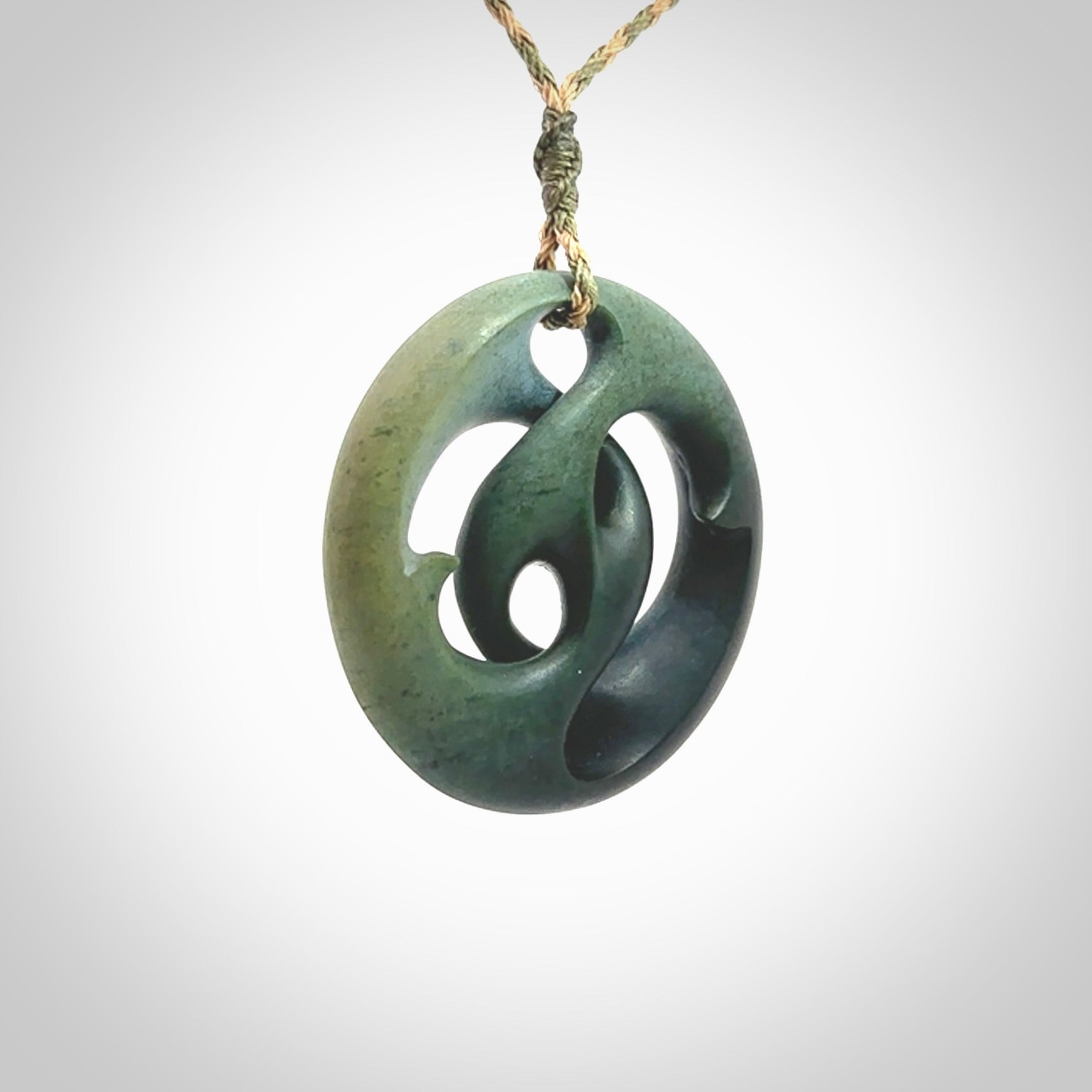 Hand carved New Zealand jade, complex twist drop pendant. Hand made complex twist pendant hand carved in New Zealand. Made by NZ Pacific, jade jewellery for sale online. One only hand made by Kerry Thompson.