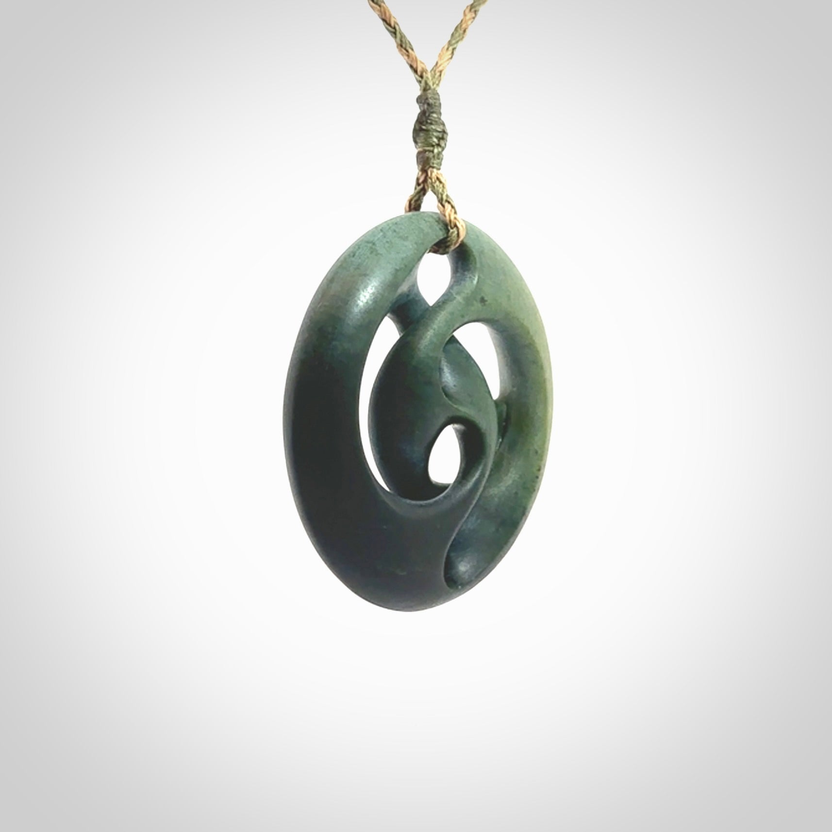 Hand carved New Zealand jade, complex twist drop pendant. Hand made complex twist pendant hand carved in New Zealand. Made by NZ Pacific, jade jewellery for sale online. One only hand made by Kerry Thompson.