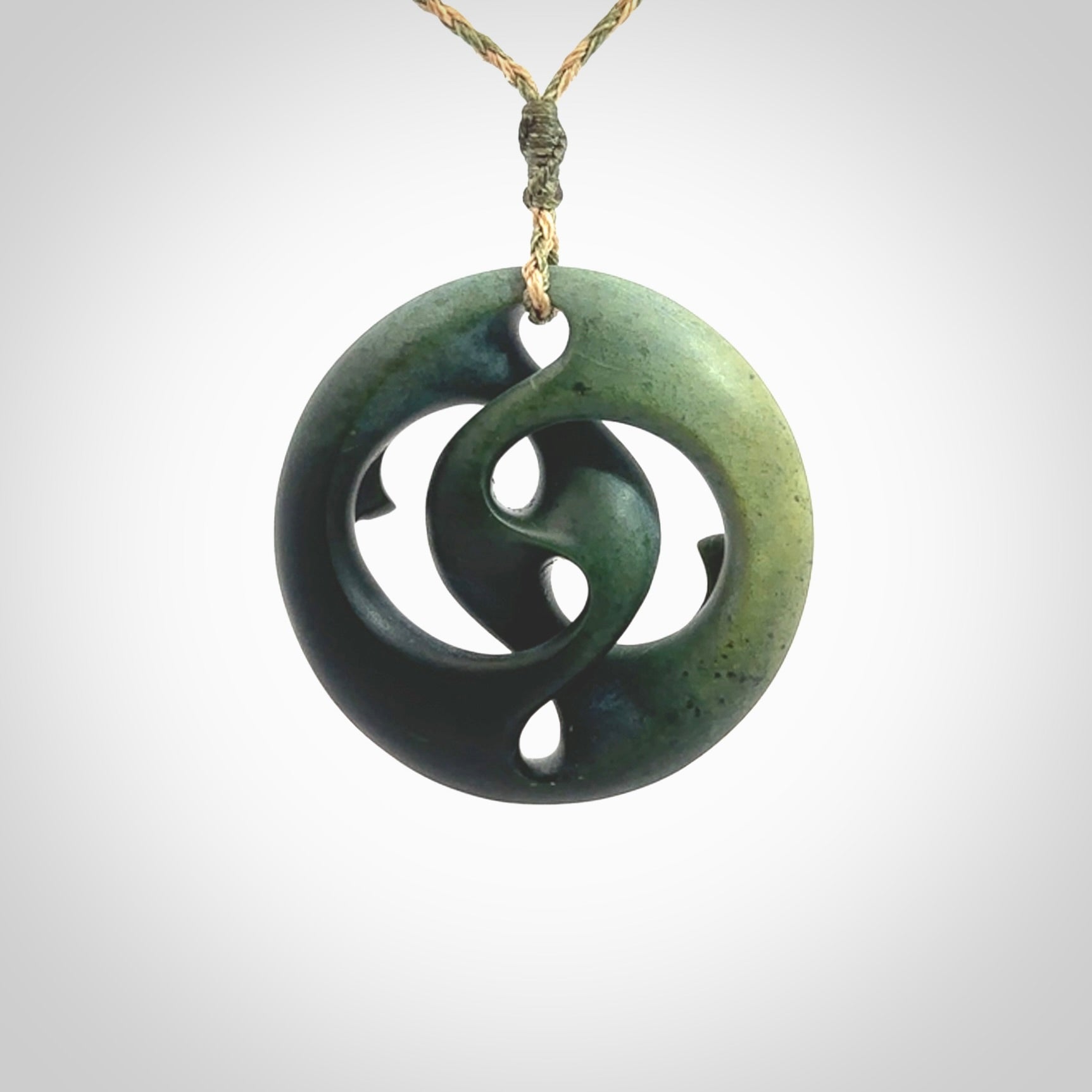 Hand carved New Zealand jade, complex twist drop pendant. Hand made complex twist pendant hand carved in New Zealand. Made by NZ Pacific, jade jewellery for sale online. One only hand made by Kerry Thompson.