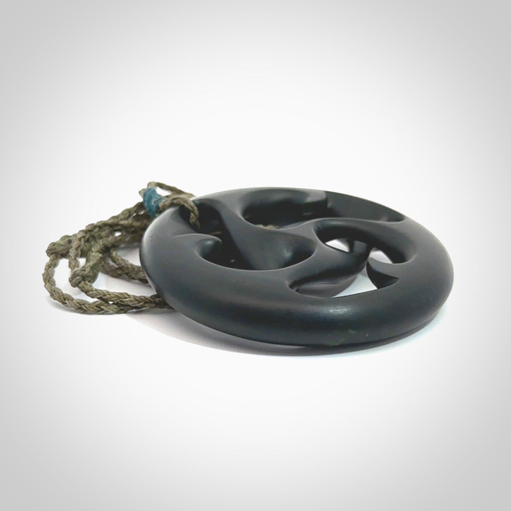 Hand carved New Zealand jade, complex twist drop pendant. Hand made complex twist pendant hand carved in New Zealand. Made by NZ Pacific, jade jewellery for sale online. One only hand made by Kerry Thompson.