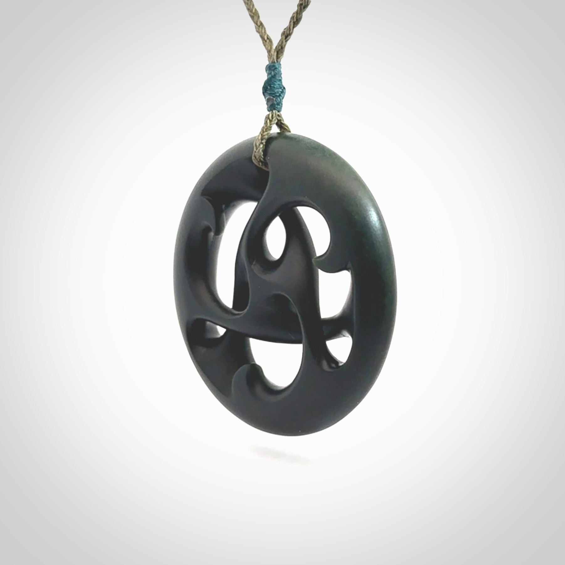 Hand carved New Zealand jade, complex twist drop pendant. Hand made complex twist pendant hand carved in New Zealand. Made by NZ Pacific, jade jewellery for sale online. One only hand made by Kerry Thompson.