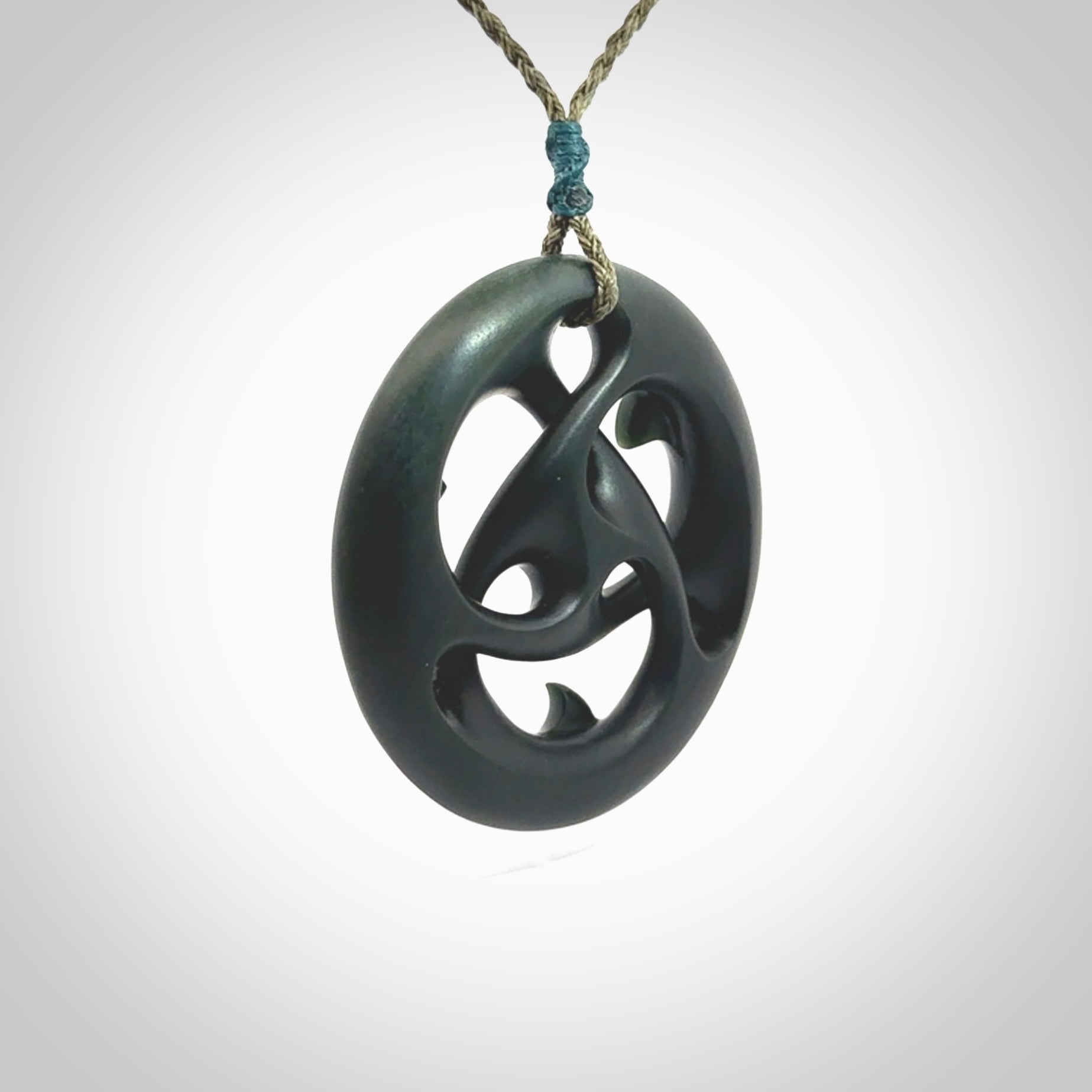 Hand carved New Zealand jade, complex twist drop pendant. Hand made complex twist pendant hand carved in New Zealand. Made by NZ Pacific, jade jewellery for sale online. One only hand made by Kerry Thompson.