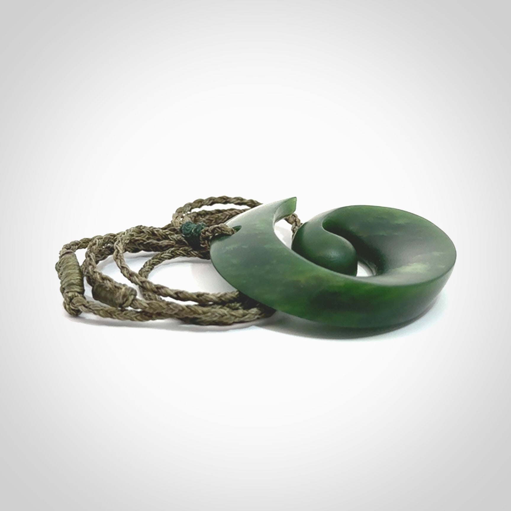 A hand carved koru pendant from New Zealand Jade. The cord is a green colour and is an adjustable length. A large hand made Koru necklace by New Zealand artist Kerry Thompson.