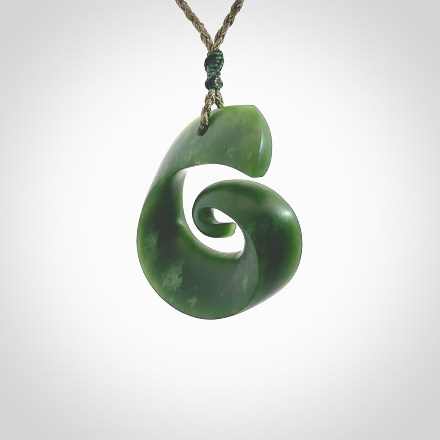 A hand carved koru pendant from New Zealand Jade. The cord is a green colour and is an adjustable length. A large hand made Koru necklace by New Zealand artist Kerry Thompson.