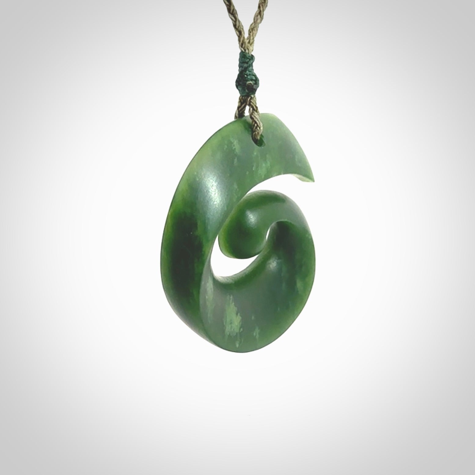 A hand carved koru pendant from New Zealand Jade. The cord is a green colour and is an adjustable length. A large hand made Koru necklace by New Zealand artist Kerry Thompson.