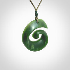 A hand carved koru pendant from New Zealand Jade. The cord is a green colour and is an adjustable length. A large hand made Koru necklace by New Zealand artist Kerry Thompson.