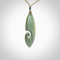 A hand carved koru pendant from New Zealand Inanga Jade. The cord is a tan/khaki colour and is an adjustable length. A large hand made Koru necklace by New Zealand artist Kerry Thompson.