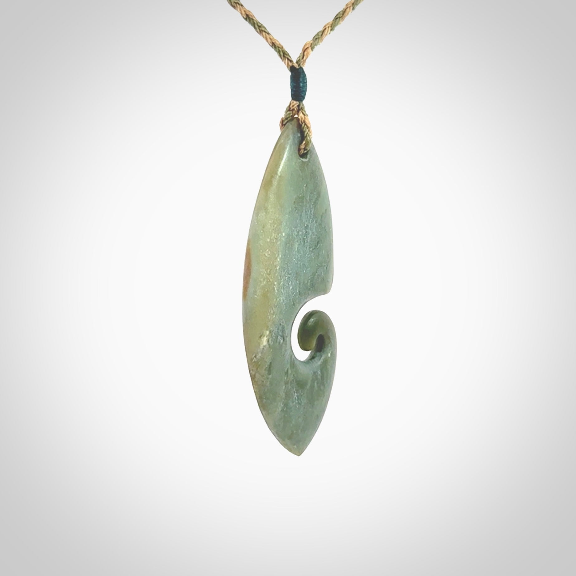 A hand carved koru pendant from New Zealand Inanga Jade. The cord is a tan/khaki colour and is an adjustable length. A large hand made Koru necklace by New Zealand artist Kerry Thompson.