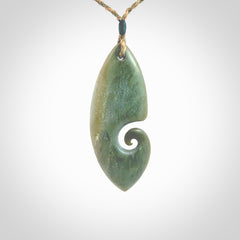 A hand carved koru pendant from New Zealand Inanga Jade. The cord is a tan/khaki colour and is an adjustable length. A large hand made Koru necklace by New Zealand artist Kerry Thompson.