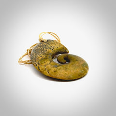 A hand carved koru pendant from New Zealand Flower Jade. The cord is a oat colour and is an adjustable length. A large hand made Koru necklace by New Zealand artist Kerry Thompson.