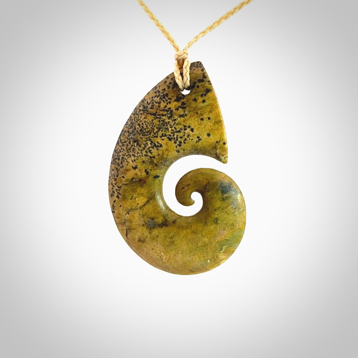 A hand carved koru pendant from New Zealand Flower Jade. The cord is a oat colour and is an adjustable length. A large hand made Koru necklace by New Zealand artist Kerry Thompson.