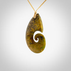 A hand carved koru pendant from New Zealand Flower Jade. The cord is a oat colour and is an adjustable length. A large hand made Koru necklace by New Zealand artist Kerry Thompson.