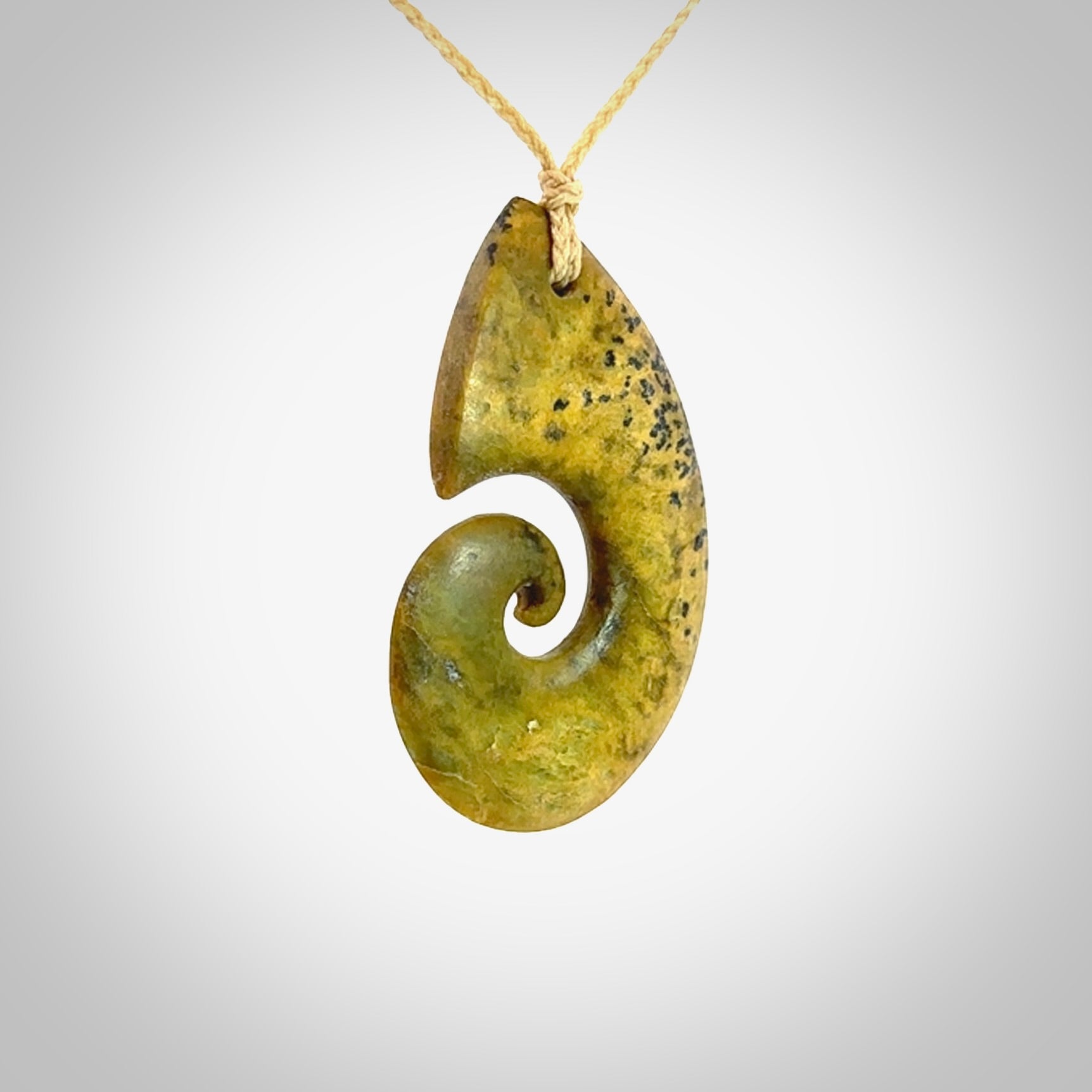 A hand carved koru pendant from New Zealand Flower Jade. The cord is a oat colour and is an adjustable length. A large hand made Koru necklace by New Zealand artist Kerry Thompson.