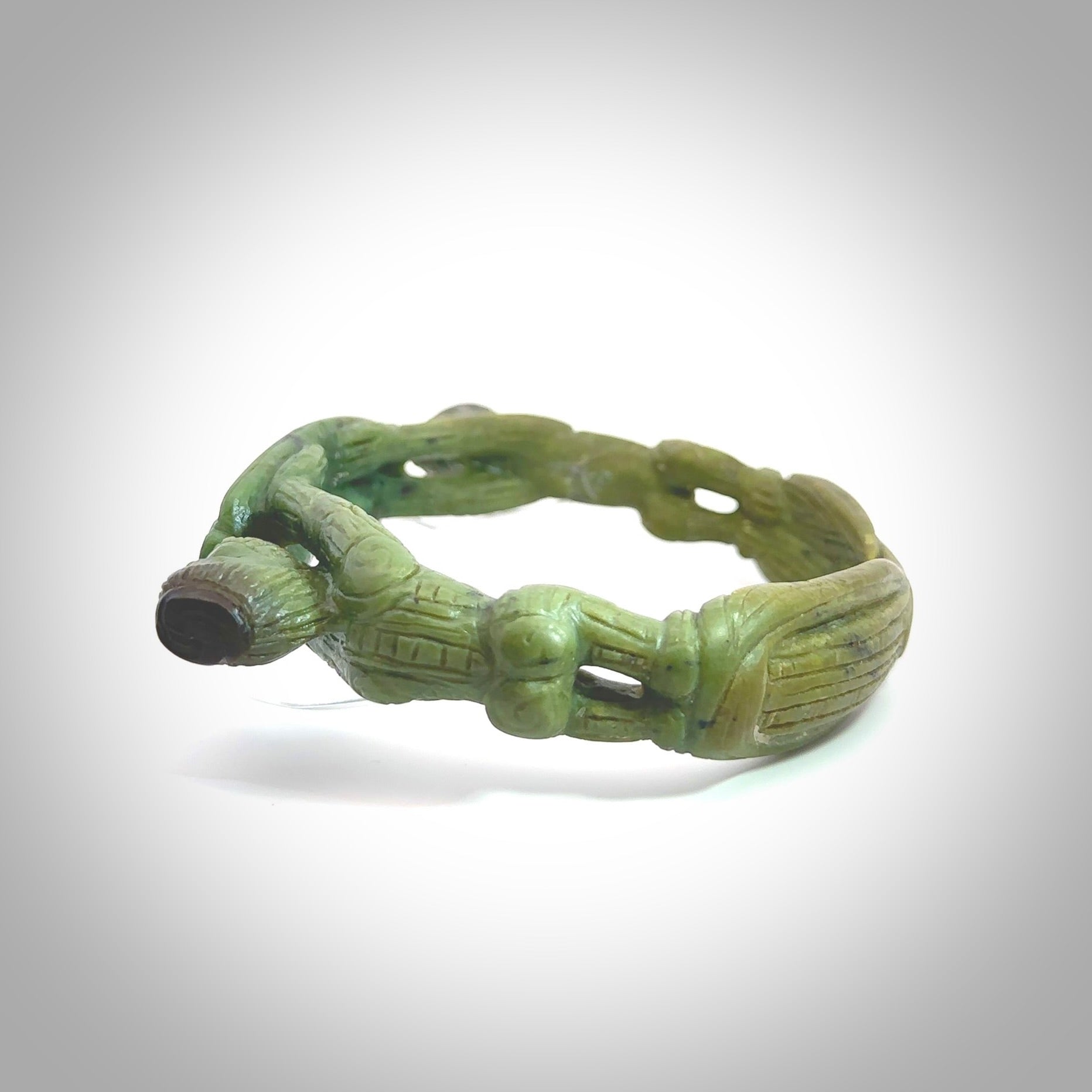 A photo of a New Zealand Jade bangle. This is a one off, statement piece - hand crafted here in New Zealand by Jeromy. Unique Art to Wear. Gifts for all lovers of hand made Art to Wear. One only collectors pendant. Delivery is free worldwide.