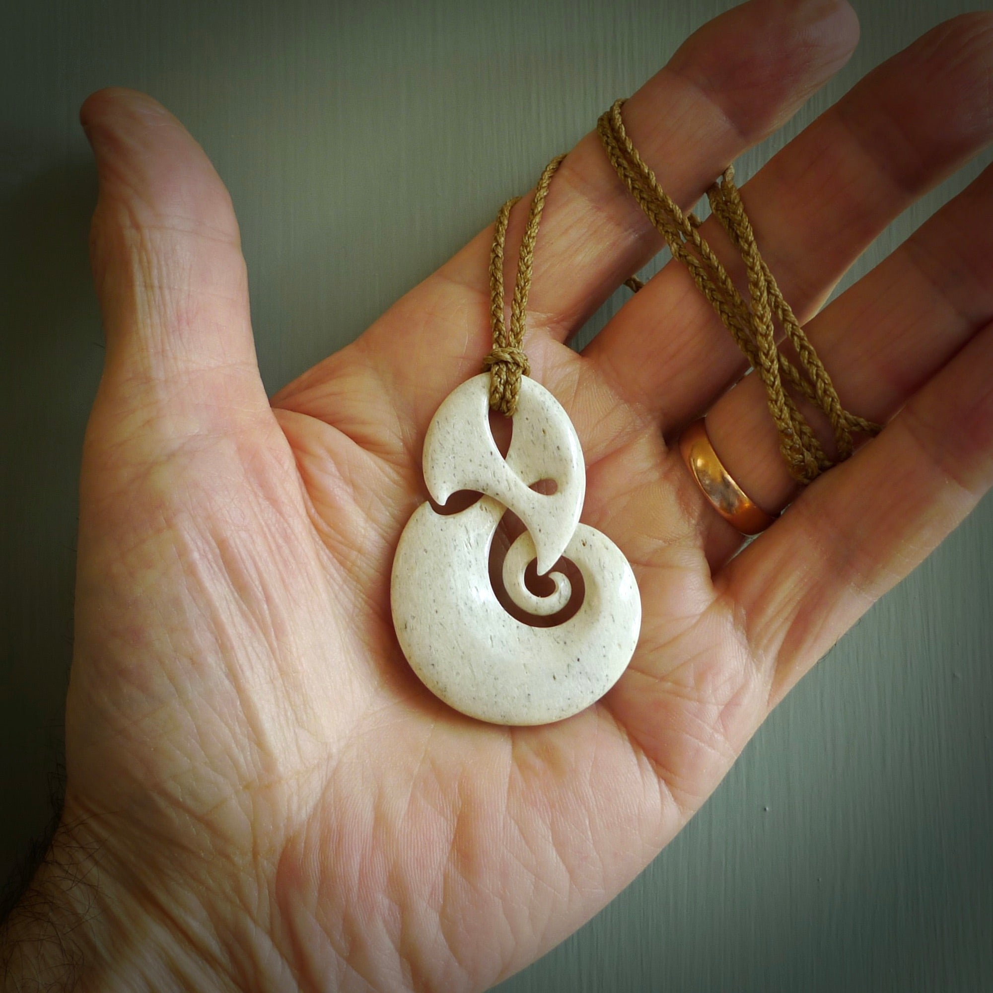 A hand carved path of life design pendant from Whale Bone. The cord tan and is adjustable. Large hand made Koru necklaces by New Zealand artist Kerry Thompson.