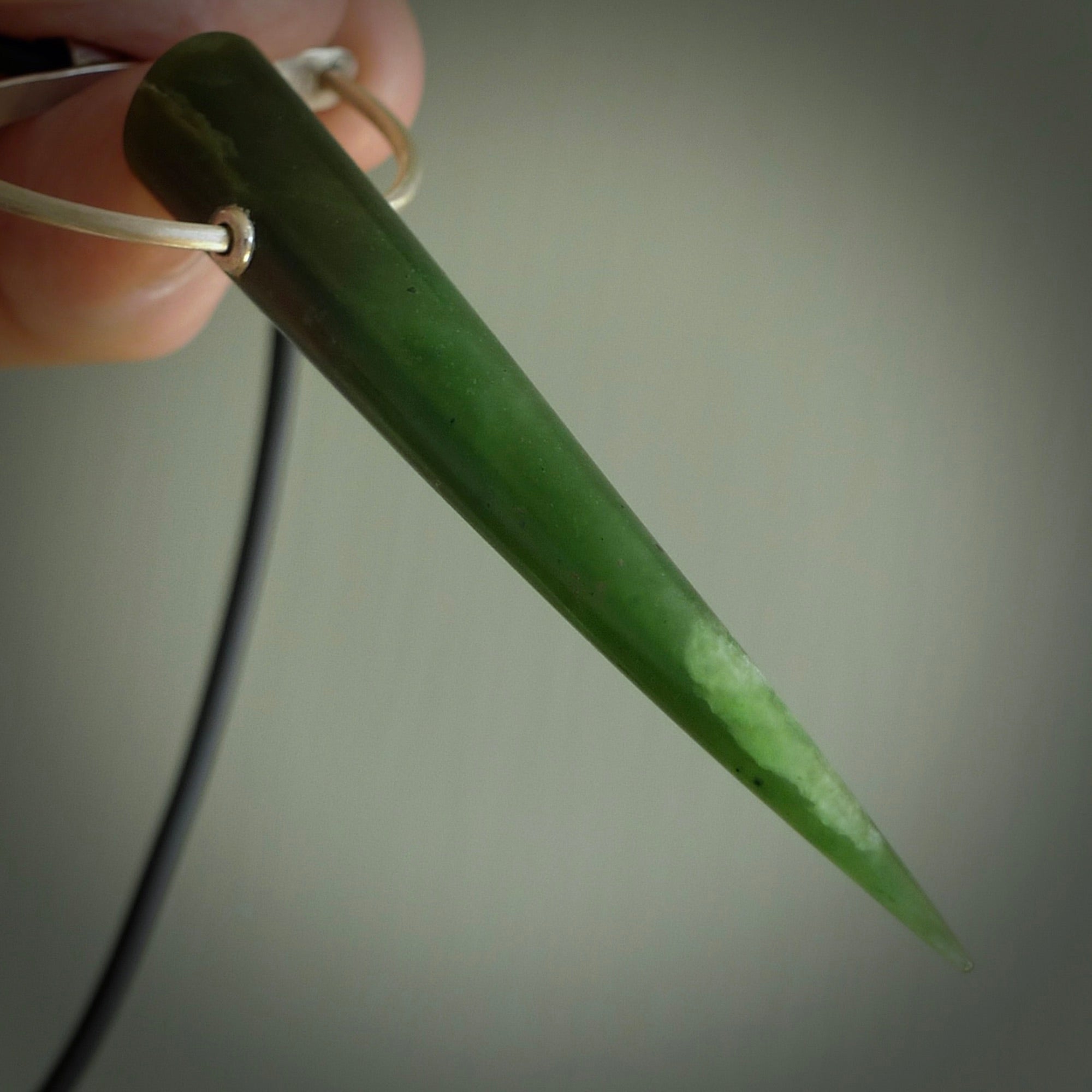 A photo of a New Zealand Jade drop pendant with sterling silver. This is a stylish statement piece - hand crafted here in New Zealand by Ana Krakosky. Unique Art to Wear. Gifts for all lovers of hand made Art to Wear.