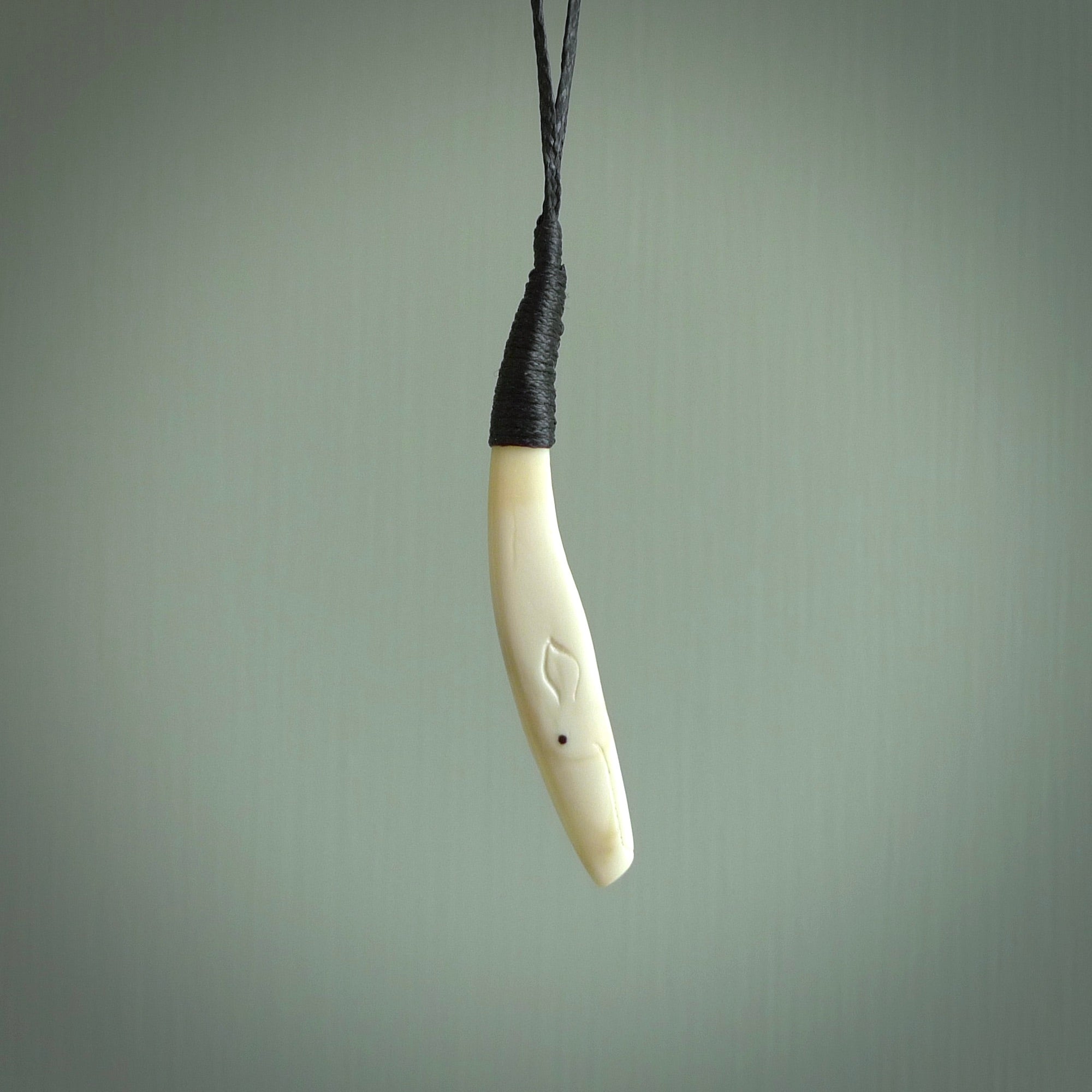 Hand carved sperm whale pendant, carved for us by Fumio Noguchi. This piece is carved from bone and is a fantastic depiction of these giants of the deep. This particular piece is a sperm whale design and is lovingly carved. Free shipping worldwide.