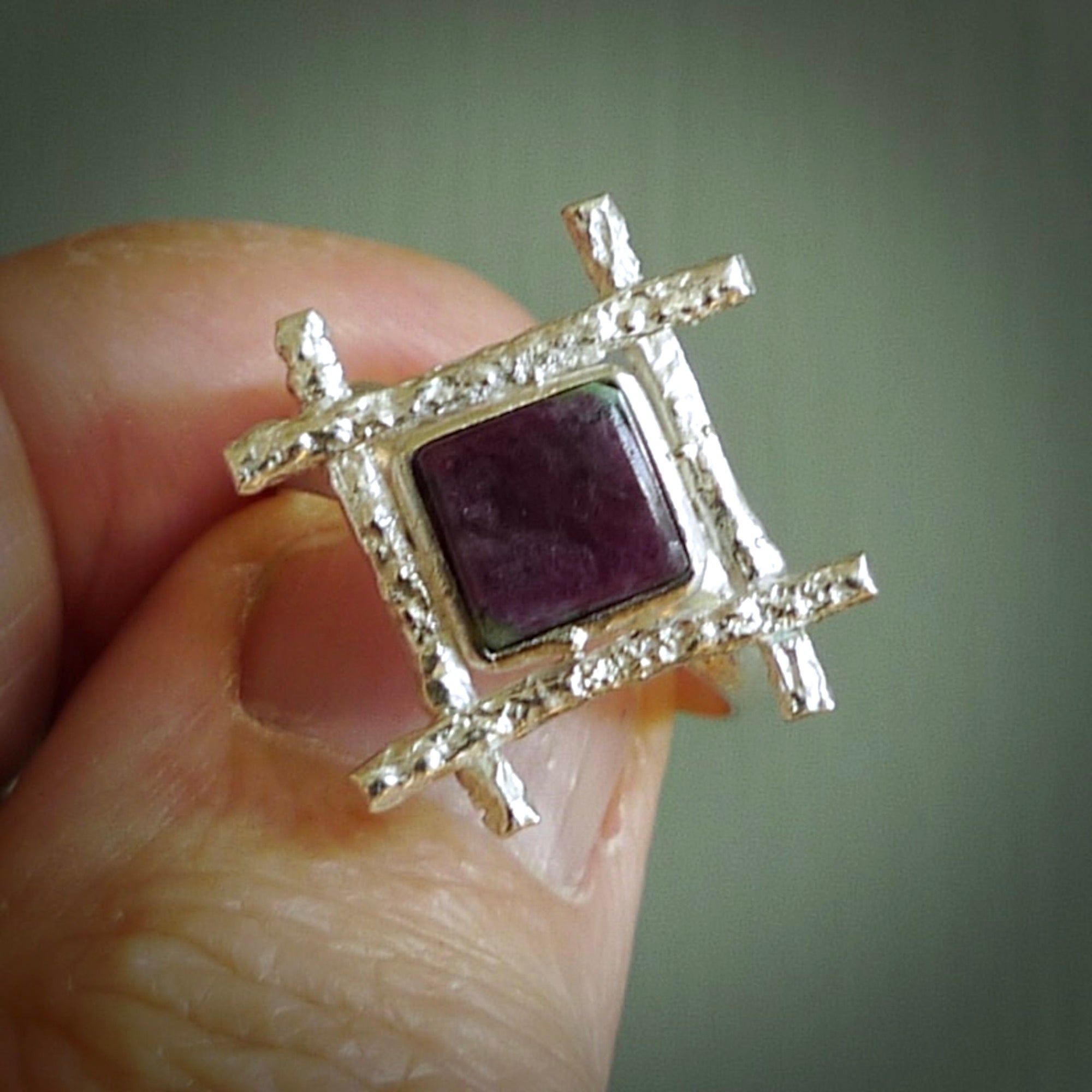 This is a handcrafted New Zealand Ruby, stone with sterling silver ring. This is a solid little work of art. We ship this worldwide for free and are happy to answer any questions that you may have about these or other products on our website. Hand made by Ana Krakosky and delivered in a woven kete pouch.