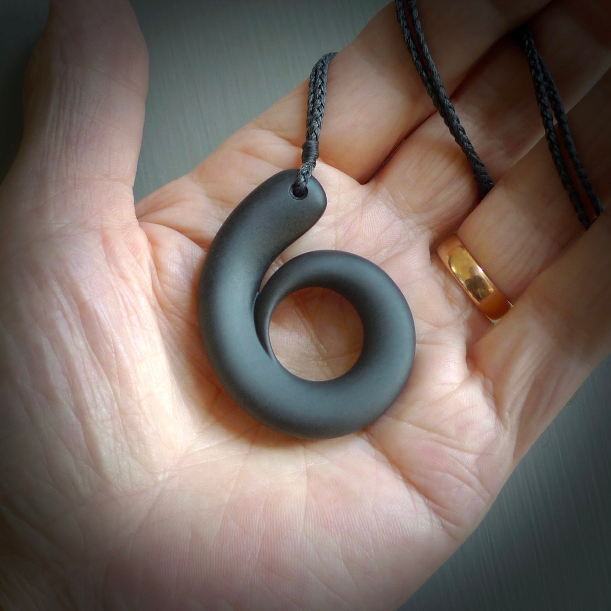 Argillite stone pendant shaped as a tusk. Hand carved by Rhys Hall for NZ Pacific. Handmade contemporary jewellery for sale online.