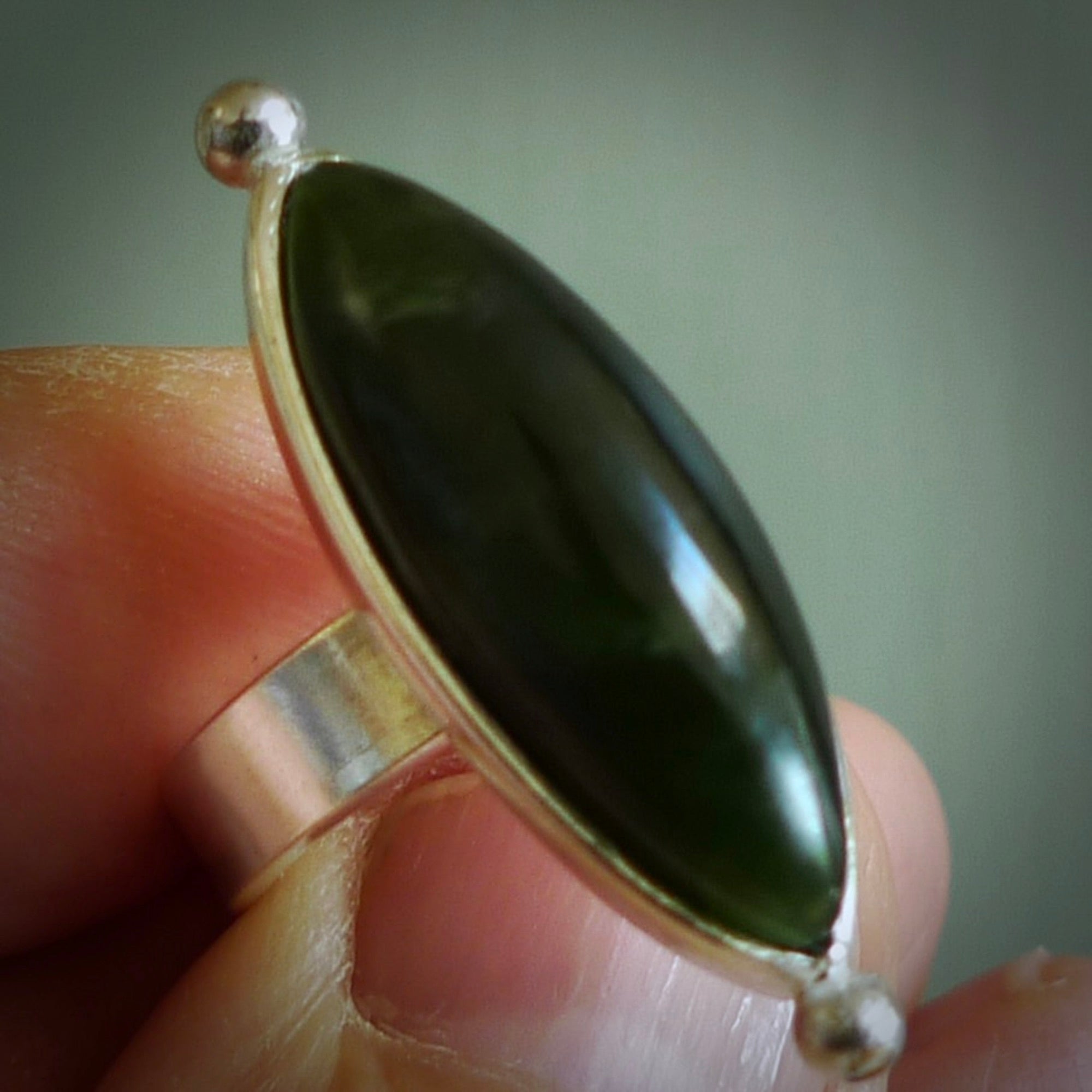 This is a handcrafted New Zealand Pounamu, Jade and sterling silver ring. This is a solid little work of art. We ship this worldwide for free and are happy to answer any questions that you may have about these or other products on our website. Hand made by Ana Krakosky. Contemporary art to wear, one only ring. Delivered with Express Courier and packaged in a woven kete pouch.