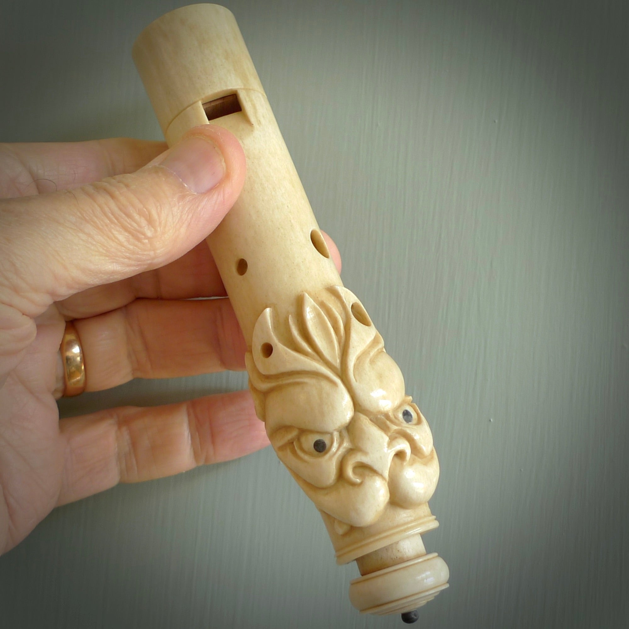 A contemporary hand carved flute. This piece is made from bone and is a fully functioning musical instrument and can be played. Beautiful art hand made by Yuri Terenyi. Flute with Dragons head.