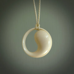 A hand carved masterpiece. A complex contemporary drop pendant carved from bone by Yuri Terenyi for NZ Pacific. This is a true piece of wearable art which is collectible. A one-off masterpiece and quite unique. Delivered with adjustable ice white necklace cord.