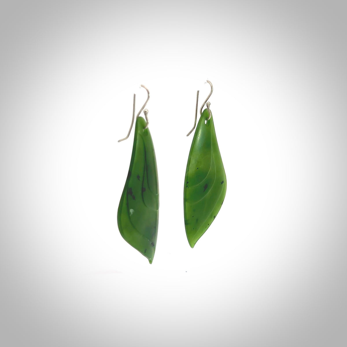 These are stunning large butterfly wing shaped drop jade earrings carved in New Zealand by Josey Coyle. It is carved from a deep, semi-translucent green piece of New Zealand Jade and with Sterling Silver hooks and findings.